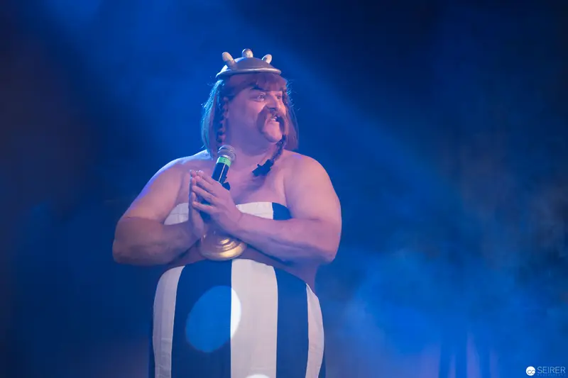 Costumed Performer Singing with Dramatic Blue Stage Lighting at AniNite 2018