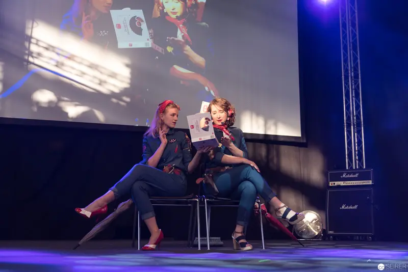 AniNite 2018: Two Performers on Stage in Dynamic Seated Pose