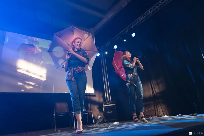 Haruka and Takuya Performing at AniNite 2018 Concert with Umbrellas and Dramatic Lighting
