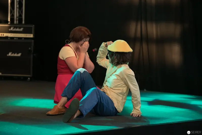 Two Performers in Contemplative Moment at AniNite 2018 Concert Stage