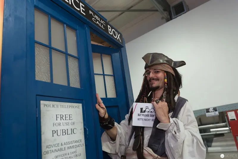 Costumed Performer Posing Beside Police Box at Event Location