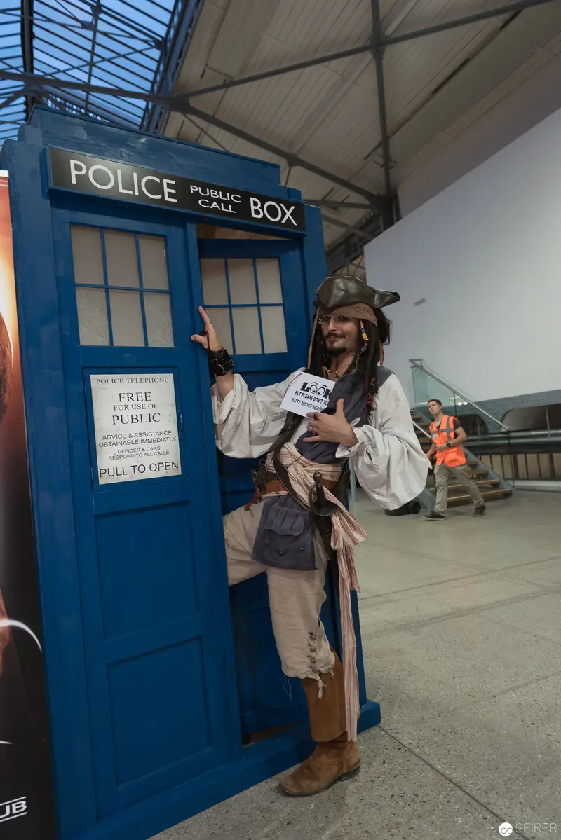 Costumed Performer Posing with TARDIS Police Box at Indoor Venue