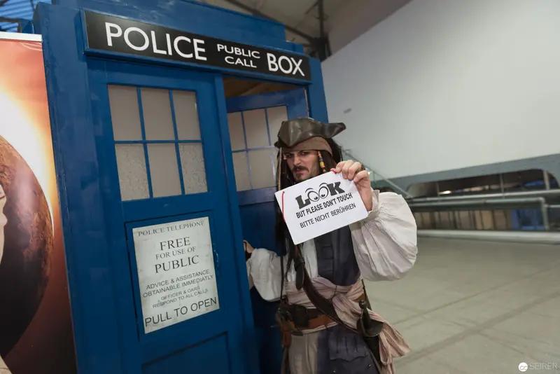 Doctor Who TARDIS Police Box with Costumed Fan Holding Promotional Sign
