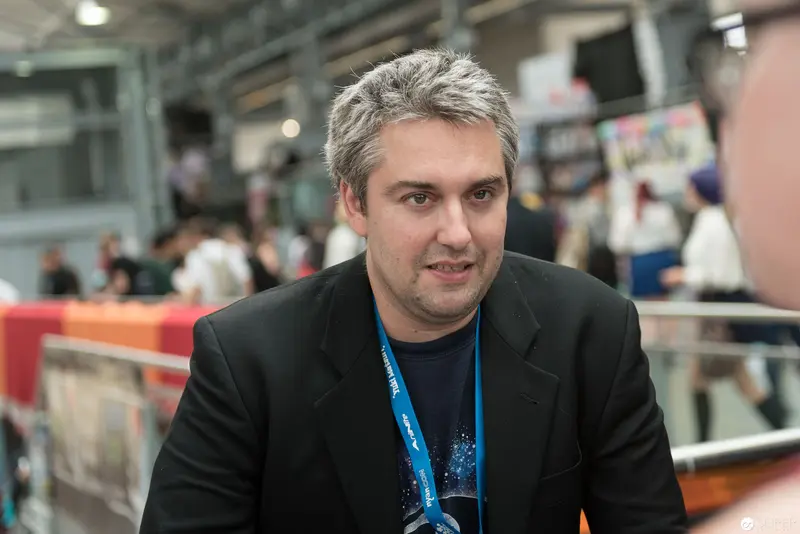Gray-Haired Professional in Black Jacket at Conference or Convention