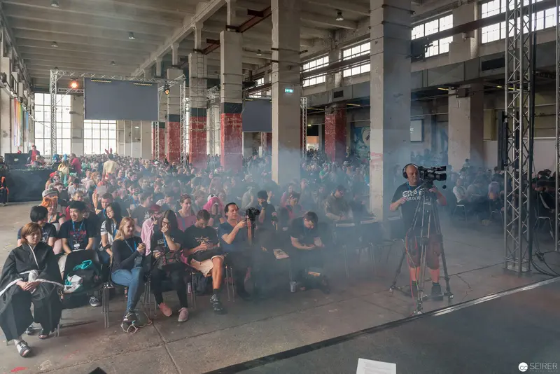 AniNite 2018: Audience Gathered in Smoky Industrial Venue During Performance