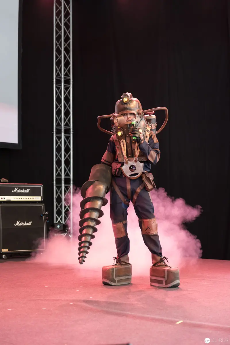 Costumed Performer with Drill Prop on Pink Stage at AniNite 2018