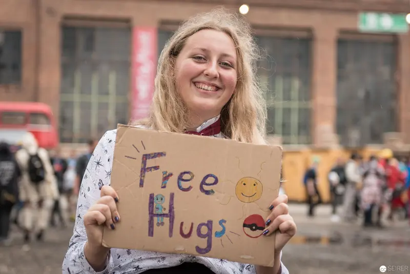 Cheerful Demonstrator Offering Free Hugs on City Street