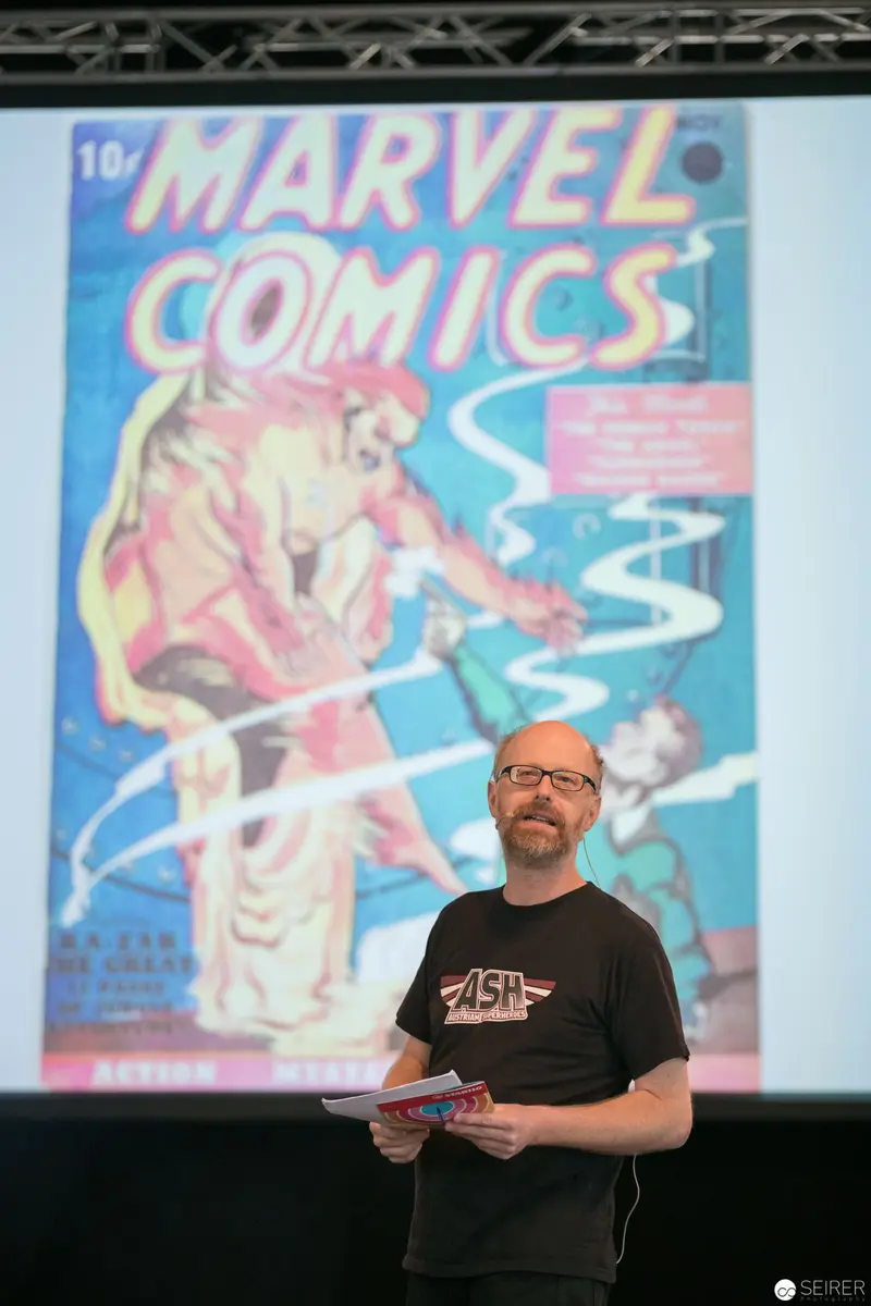 Marvel Comics Poster Display with Speaker at Event