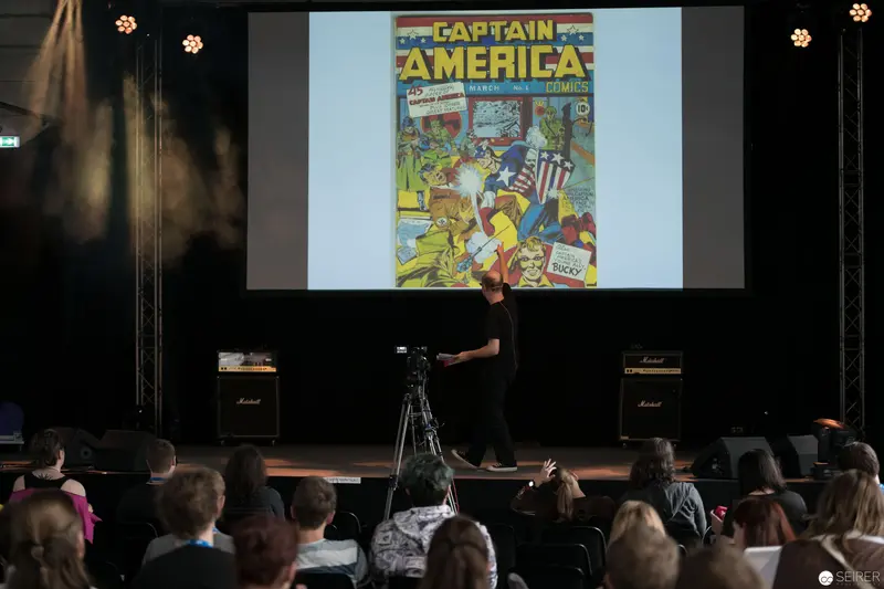 Comic Book Presentation: Captain America Cover Displayed at Academic Lecture