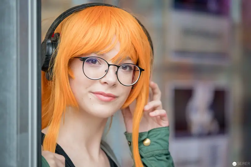 Young Woman in Orange Hair and Headphones at AniNite 2018 Cultural Event