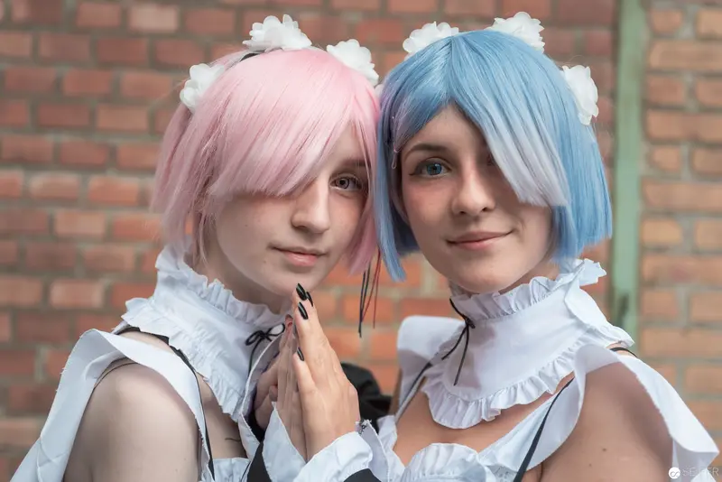 Cosplay Duo in Pastel Wigs and White Ruffled Costumes at AniNite 2018