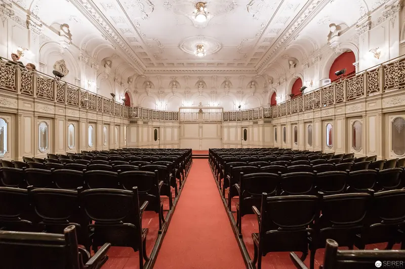 Ornate Interior of Classical Performance Hall with Balcony and Red Carpet