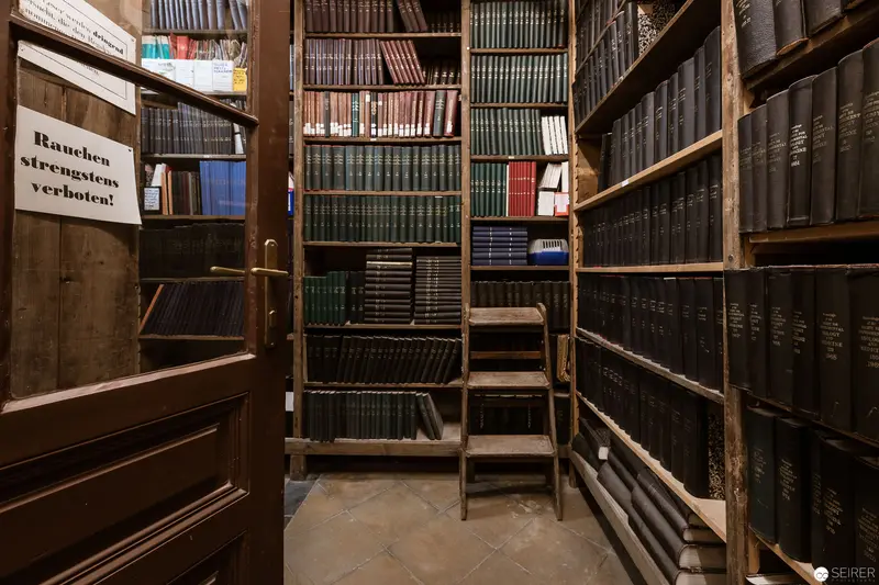 Archival Library Stacks with German No Smoking Sign and Wooden Ladder