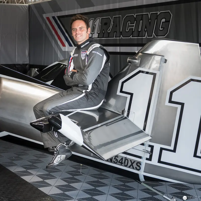 Red Bull Air Race Pilot in Racing Suit Seated in Competition Aircraft