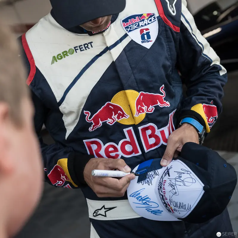 Red Bull Air Race Athlete Signing Memorabilia in Team Racing Uniform