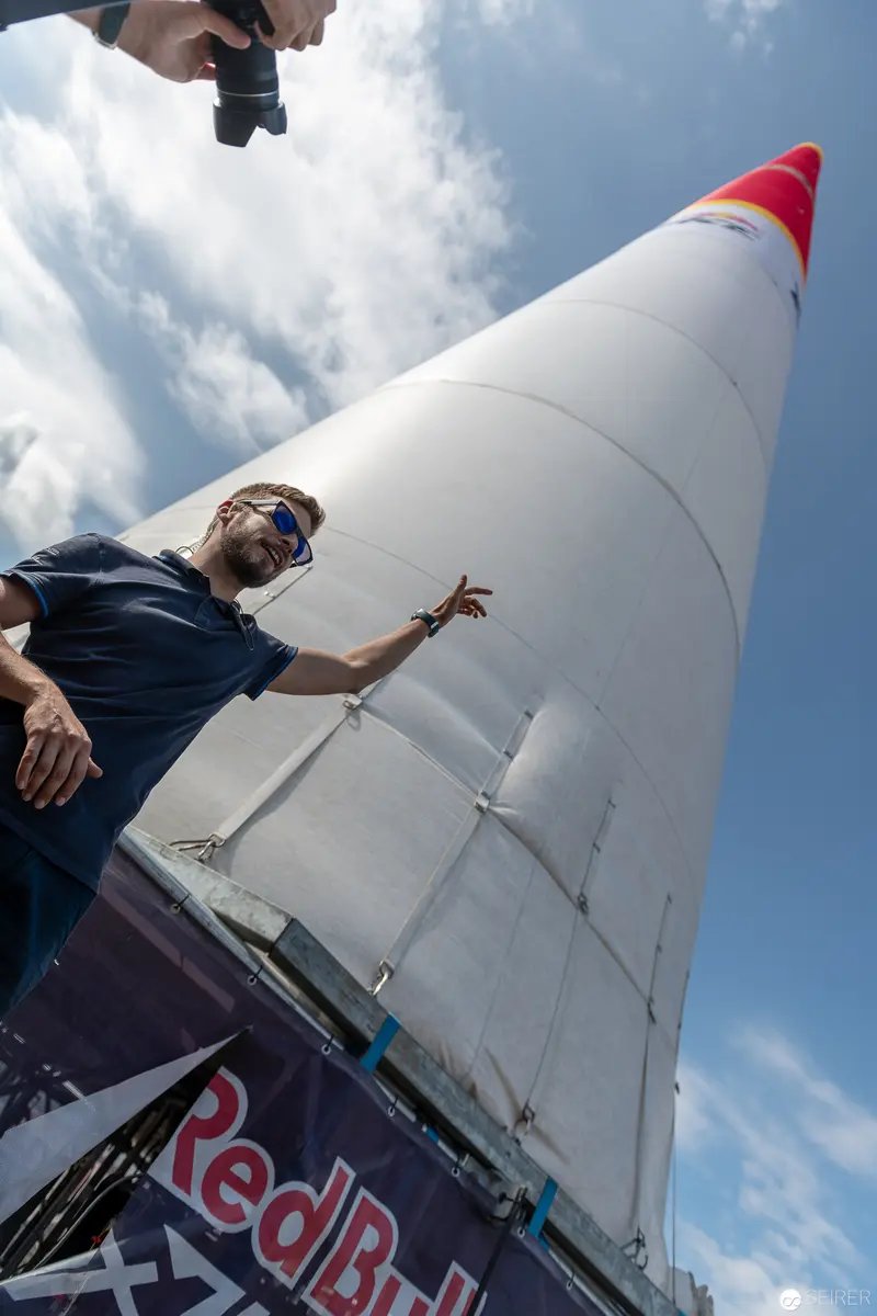 Red Bull Air Race Competitor Gesturing Beside White Race Aircraft