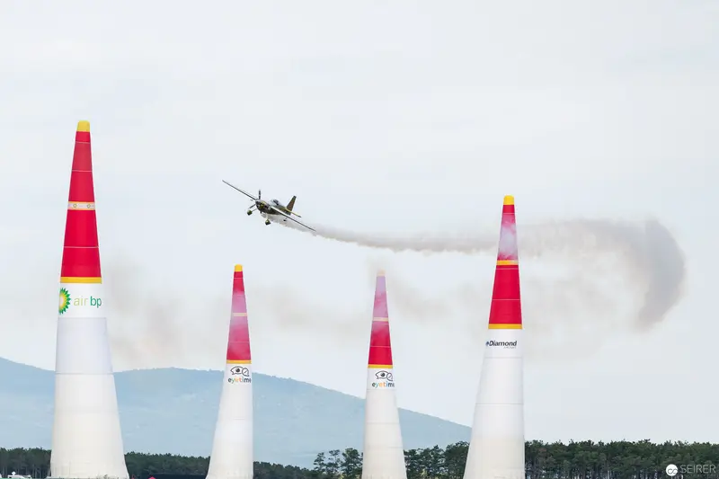 Red Bull Air Race Plane Navigating Precisely Between Distinctive Marker Pylons