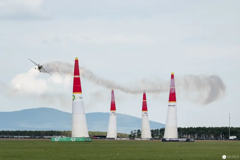 Red Bull Air Race: Precision Flying Between Marker Pylons in Landscape Setting