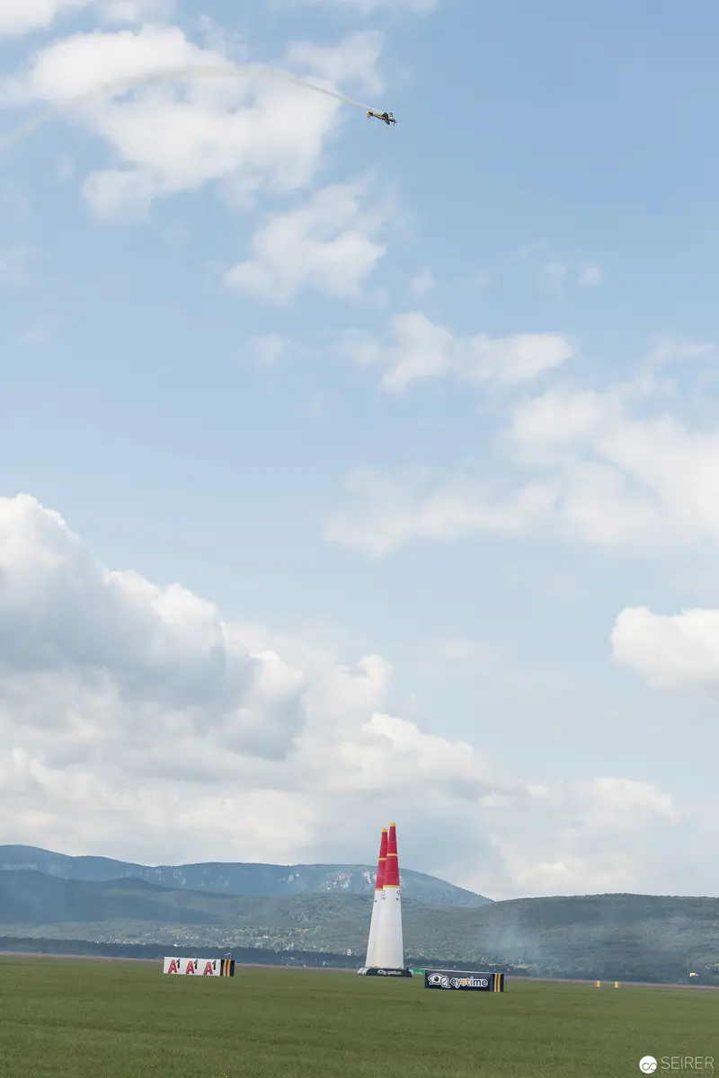 Red Bull Air Race Pylon Marker Against Expansive Clouded Landscape