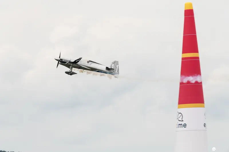 Red Bull Air Race Stunt Plane Executing Precision Aerial Maneuver Near Marker Pylon