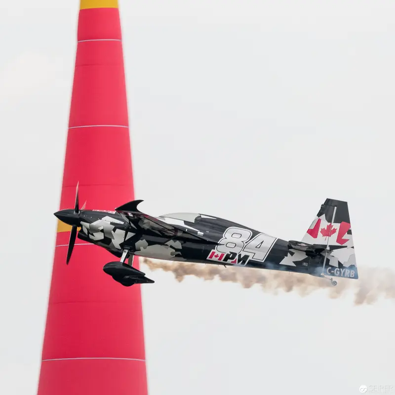 Canadian Aerobatic Aircraft Navigating Red Pylon in Red Bull Air Race