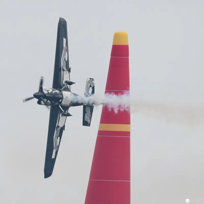 Red Bull Air Race Precision Aerobatics: Propeller Plane Near Vibrant Pylon