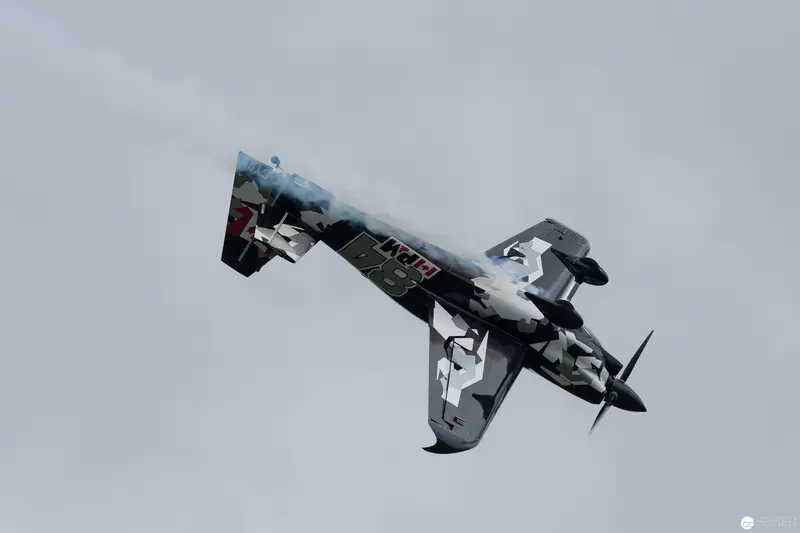 Red Bull Air Race Stunt Plane Executing Dramatic Aerial Maneuver in Monochrome