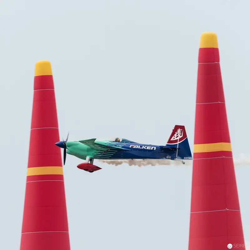 Red Bull Air Race Precision: Sleek Aircraft Navigating Between Crimson Pylons