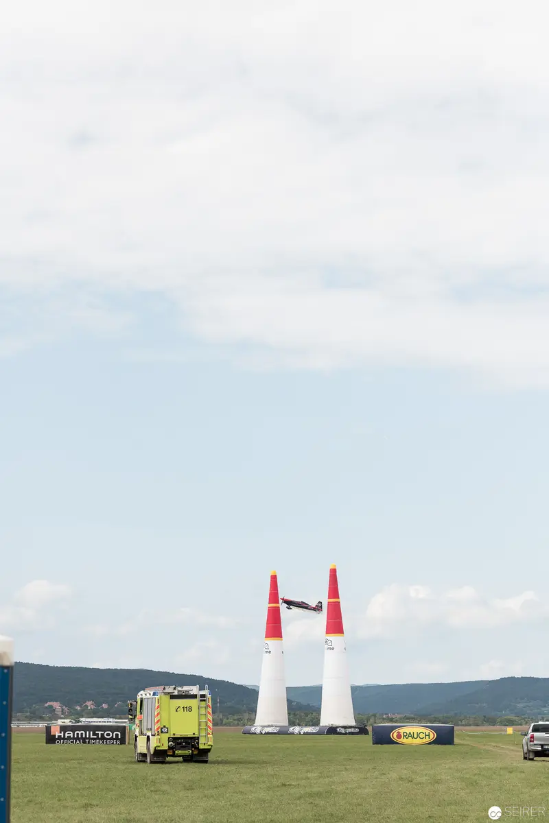 Red Bull Air Race Ground Setup with White Pylons and Race Vehicle