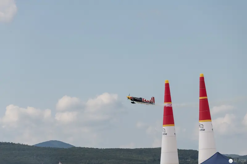 Red Bull Air Race: Precision Aircraft Navigating Between Iconic Pylons in Mountainous Landscape