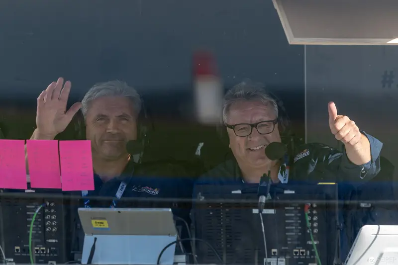 Red Bull Air Race Commentators Signal Thumbs Up and Wave from Control Booth