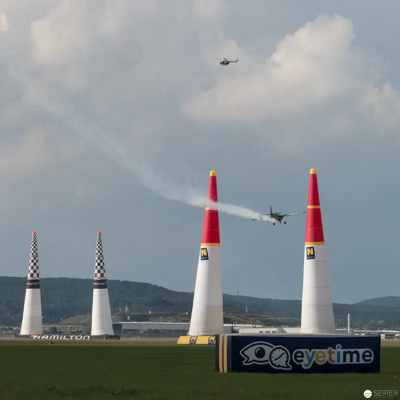 Red Bull Air Race Planes Navigate Precision Pylons Against Clouded Sky