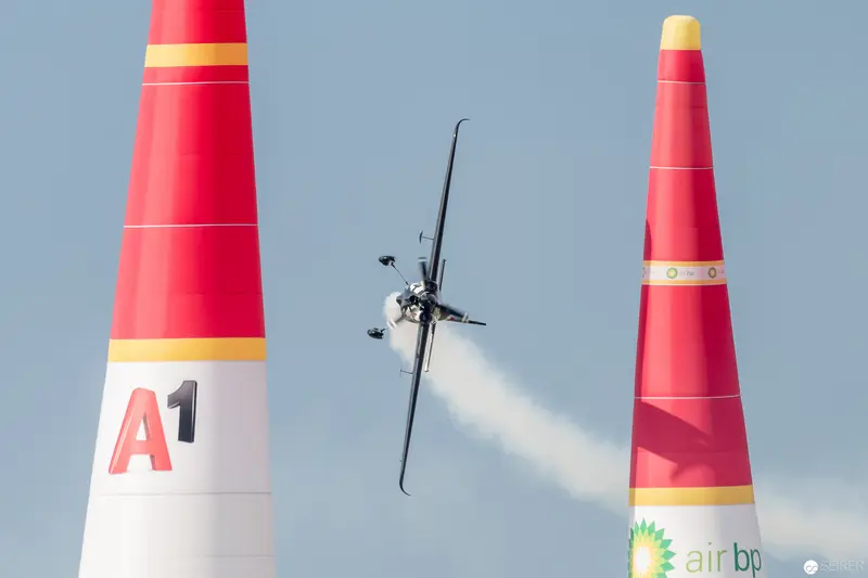 Red Bull Air Race Pilot Navigating Between Colorful Pylons in Precision Flight