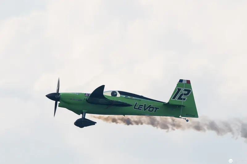 Green Le Vot Aerobatic Aircraft Performing Precision Maneuver at Air Race