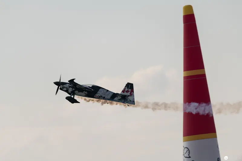Red Bull Air Race Stunt Plane Performing Precision Aerobatics Near Marker Pylon