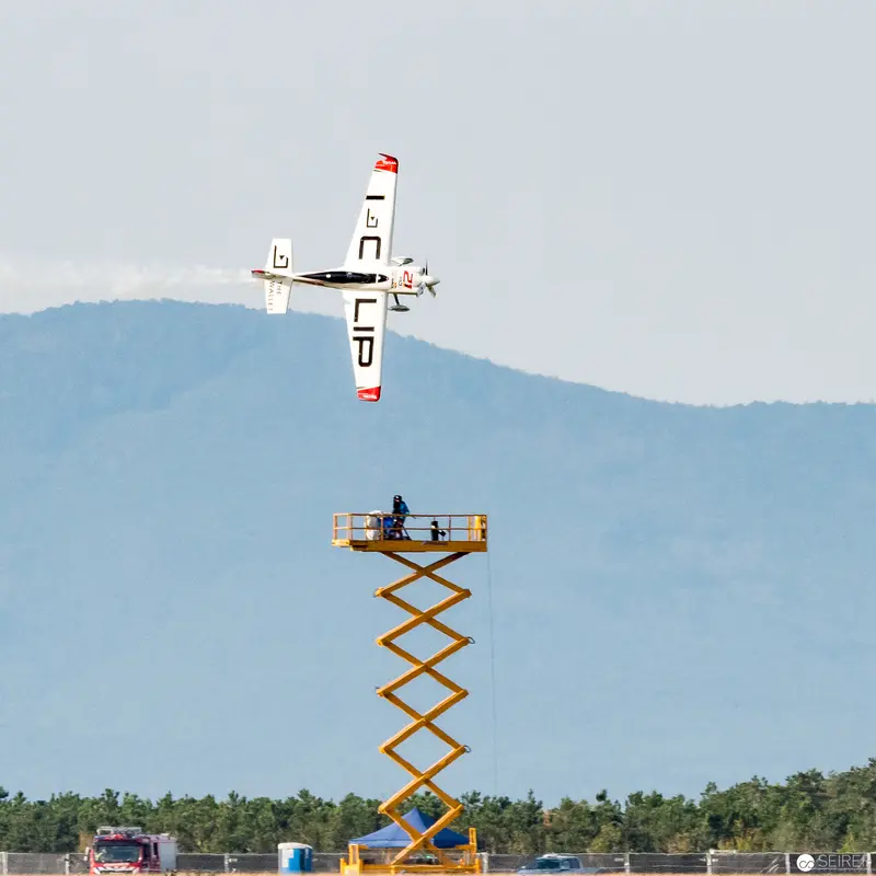 Red Bull Air Race Stunt Plane Hovering Above Scissor Lift Platform