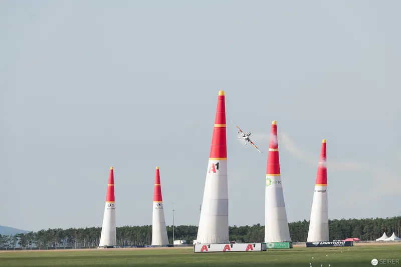 Red Bull Air Race: Precision Aircraft Navigating Tall White and Red Pylons