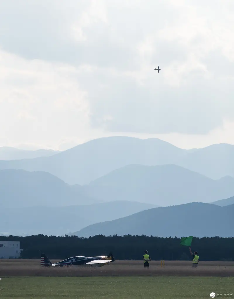 Red Bull Air Race Aerial Landscape with Distant Aircraft and Mountain Panorama
