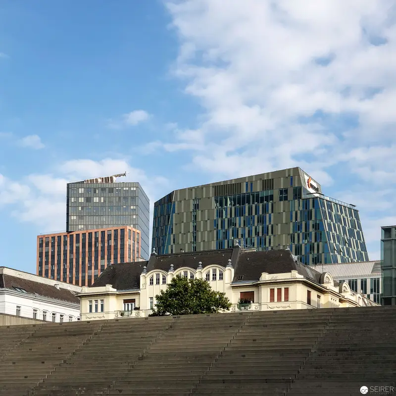 Urban Architectural Landscape: Modern Towers Juxtaposed with Historic Buildings in Vienna