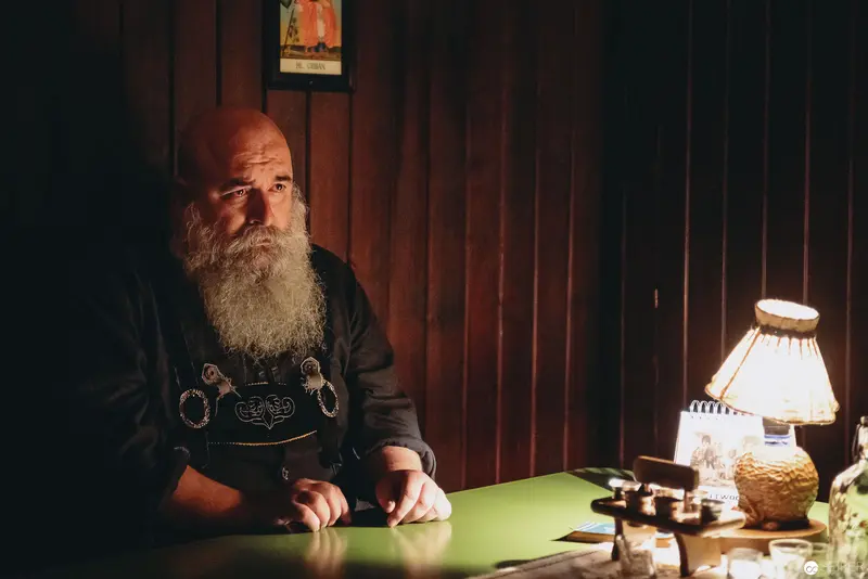 Nesterval Theater Performance "Das Dorf": Contemplative Moment with Bearded Subject