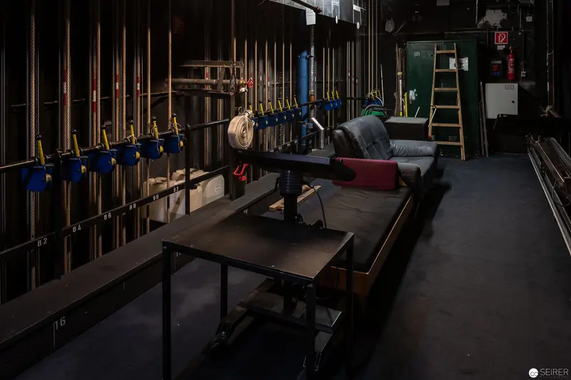Industrial Workshop Interior with Workbench and Hydraulic Clamps in Low Light