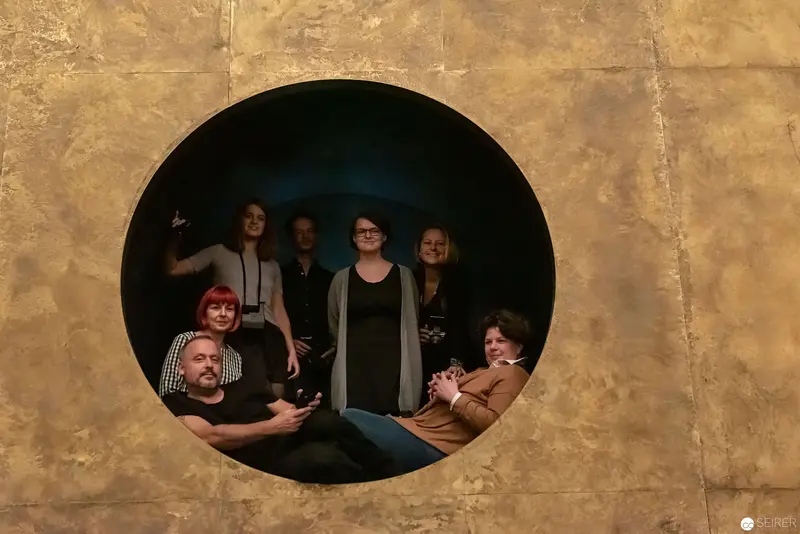 Group Portrait Within Circular Frame: Collaborative Ensemble in Monochromatic Setting