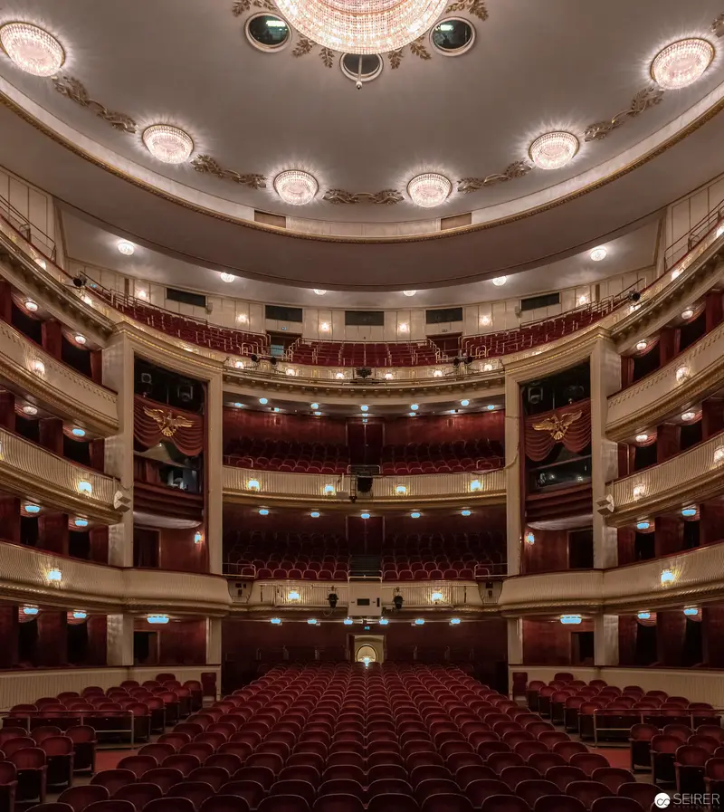 Ornate Classical Theatre Interior with Tiered Seating and Elegant Chandelier Design