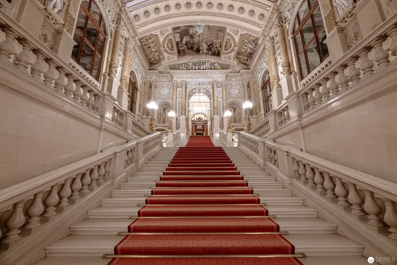 Imperial Grand Staircase with Crimson Carpet in Ornate Baroque Palace Interior
