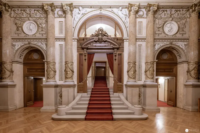 Ornate Baroque Interior with Grand Marble Staircase and Red Carpet