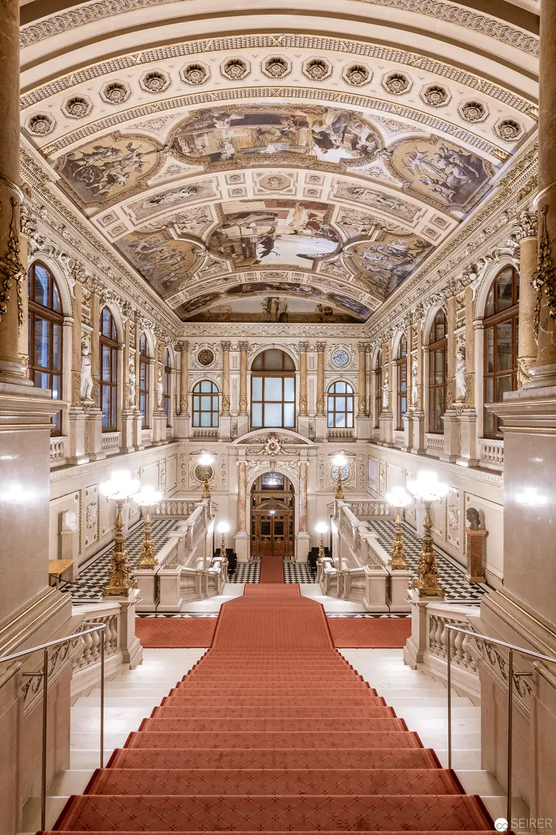 Grand Ceremonial Hall with Ornate Baroque Ceiling and Crimson Carpet Staircase