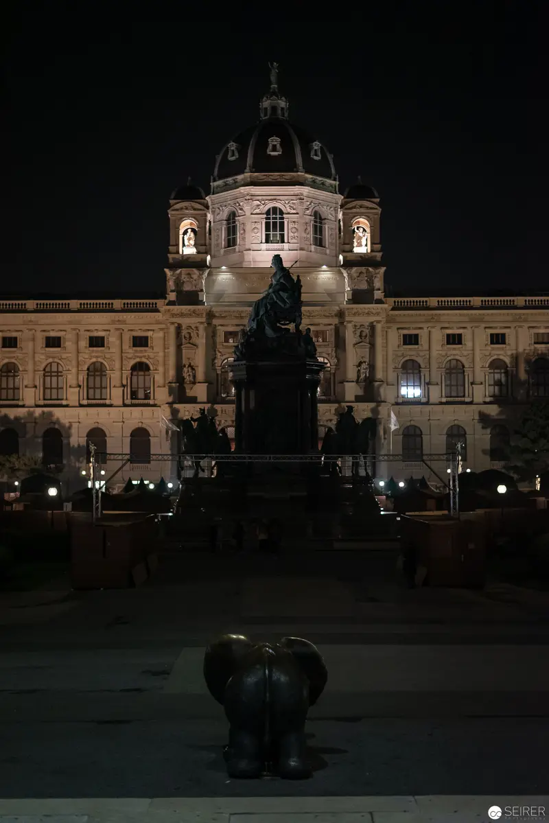 Nighttime View of Ornate Baroque Museum with Illuminated Facade and Statue