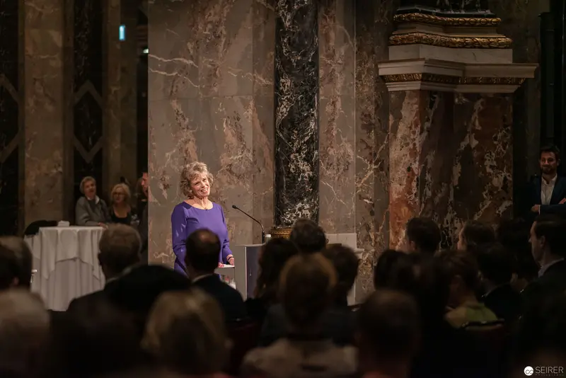 Speaker in Purple at Elegant Marble-Clad Historical Venue
