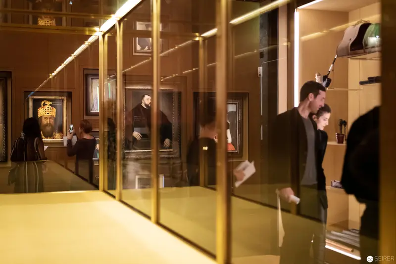 Reflective Gallery Interiors with Visitors at Museum Exhibit