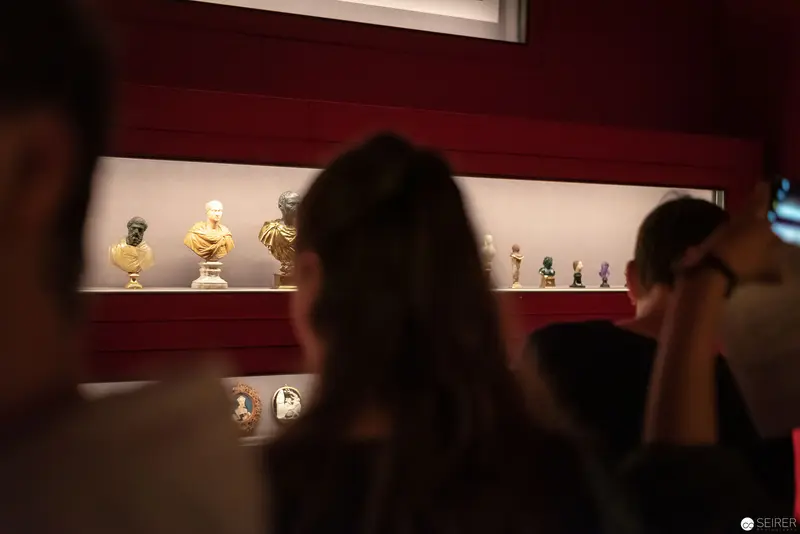 Museum Visitors Observing Classical Busts at Kunsthistorisches Museum Wien